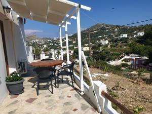 a table and chairs on the balcony of a house at Kanari Holiday Home in Gourna