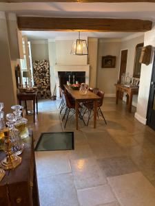 a living room with a table and a fireplace at L'aile du Chateau in Ramatuelle