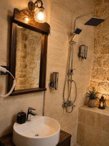 a bathroom with a sink and a shower and a mirror at Kasrı Hatun Konağı in Mardin +48 photos