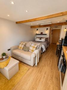 a living room with a bed and a couch at The Old Smithy in Trefriw