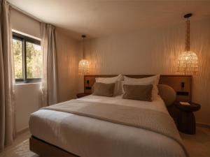 a bedroom with a large white bed with two pillows at Besai Ibiza Boutique Hotel - New Opening in San Jose +87 photos