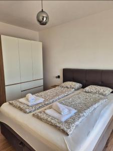 a bedroom with a large bed with two pillows on it at Guesthouse Maro in Povljana