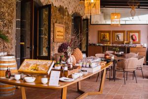 a room with tables and chairs with food on them at Relais San Giuliano in Viagrande