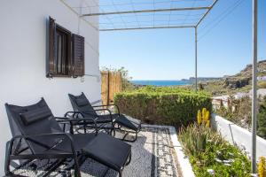 a patio with chairs and a view of the ocean at CasaLindos Spitaki in Lindos