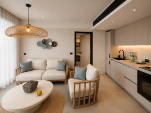 a living room with a couch and a table at Summer Scents Villa Sani by Granari Rentals in Sani Beach