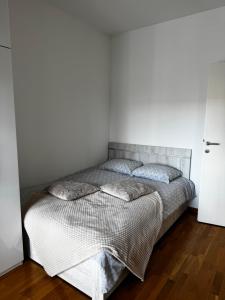 a bedroom with a bed with two pillows on it at SIENA stan na dan Doboj in Doboj