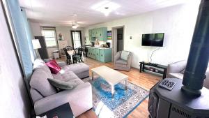 a living room with a couch and a table at Falcon Retreats in Sharbot Lake