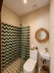 a bathroom with a toilet and a sink and a mirror at Kymata Surf Morocco in Agadir +60 photos