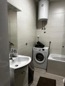 a bathroom with a washing machine and a sink at SIENA stan na dan Doboj in Doboj