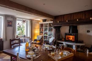 a living room with a table and a fireplace at la Ferme de Vazerat in Massiac
