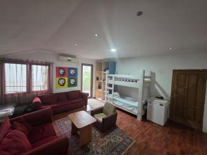 a living room with a couch and a bunk bed at Merabi Guest House in Makhinjauri