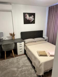 a bedroom with a bed and a desk and a desk at Chalet PuigVal 50m de la playa in Valencia +17 photos