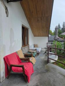 a porch with couches and chairs on a house at Merabi Guest House in Makhinjauri