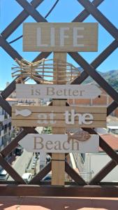 a sign that reads life is better than the beach at Terrazza Enjoy in Letojanni