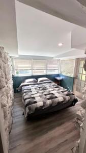 a bedroom with a large bed in a room at Falcon Retreats in Sharbot Lake