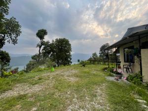 a house on the side of a hill near the water at Organic Retreats in Pokhara