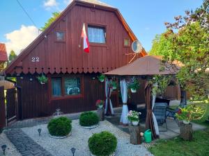 a red house with a flag on it at Nocleg u Marysi in Iwonicz-Zdrój