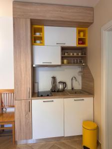 a kitchen with white cabinets and a sink at Capri apartments in Kotor