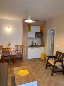 a living room with a table and a kitchen at Capri apartments in Kotor