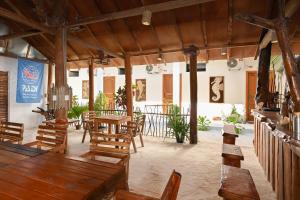 a dining room with wooden tables and chairs at Dive and Sleep - All Inclusive Diving Guesthouse - 3 Dives per day in Maamigili