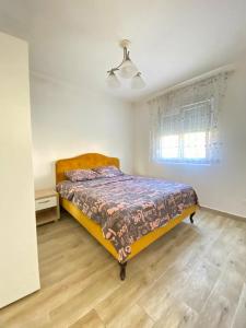 a bedroom with a bed in a white room at Batica in Radanovići