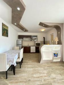 a kitchen and dining room with a table and chairs at Batica in Radanovići +6 photos