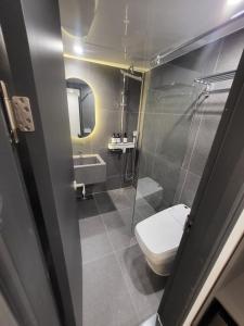 a bathroom with a toilet and a sink and a shower at LUVO Signature Hotel in Seoul