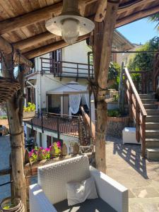 a wooden pergola with a couch on a patio at Bed & Breakfast Lujocanda in Casarza Ligure