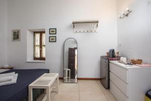 a living room with a refrigerator and a table at Al 583 di Lindos in Lindos +35 photos