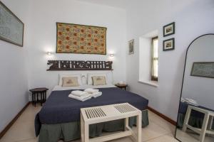a bedroom with a bed with towels on it at Al 583 di Lindos in Lindos