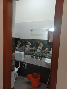 a bathroom with a sink and a toilet at Gramasiri Homestay in Sringeri +13 photos