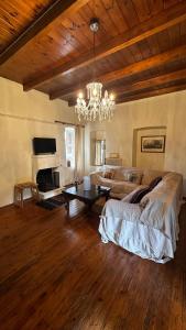 a living room with a couch and a chandelier at Panorea house in Polydrossos