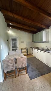 a kitchen with a table and chairs in a room at Panorea house in Polydrossos