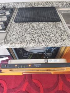 a laptop sitting on top of a kitchen counter at NicoMeli Home in Dimaro