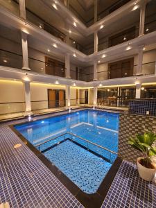a large swimming pool in a large building at Casa Sevara Hotel in Vagator