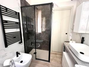 a bathroom with a shower and a white sink at Garibaldi Living - Centro Storico Parma in Parma +14 photos