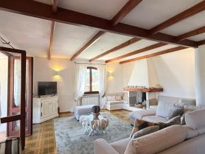 a living room with two couches and a tv at Villa Annalia in Cannigione