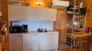 a kitchen with white cabinets and a sink at Anna Beach Holiday Home in Raja