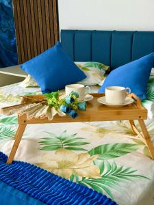 a tray with cups and saucers on a bed at sea side in Makhinjauri +189 photos