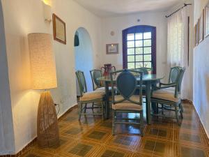 a dining room with a table and chairs at Villa Annalia in Cannigione