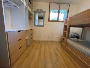 a bedroom with a bunk bed and wooden floors at Montana Appartment in Planay +1 photo