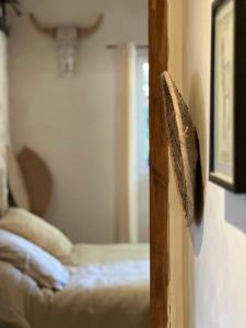 a bedroom with a bed and a mirror on a wall at chambre aux moutons in Saint-Méard-de-Gurçon