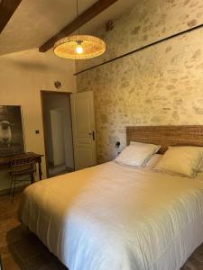 a bedroom with a large white bed in a room at chambre aux moutons in Saint-Méard-de-Gurçon
