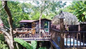 a resort with a deck and a house at Cabanes rêve d'enfant in Les Anses-dʼArlets