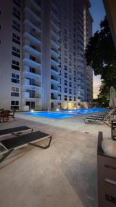 a large building with a swimming pool in front of it at Luxury Condo at Live Jaco Tower in Jacó