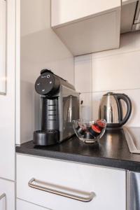 a coffee maker on a counter in a kitchen at Casa Rheinblick - Apartment B in Basel