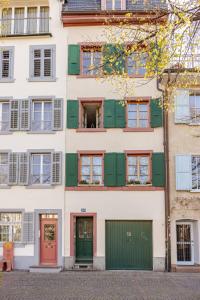 an apartment building with green doors and windows at Casa Rheinblick - Apartment B in Basel