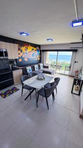 a living room with a table and some chairs at Luxury Condo at Live Jaco Tower in Jacó