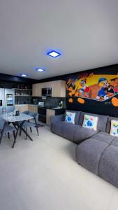 a living room with a couch and a table at Luxury Condo at Live Jaco Tower in Jacó