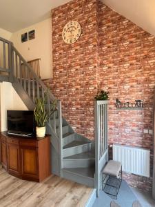 a brick wall with a staircase and a clock on it at Apartament de'Lux in Żywiec
